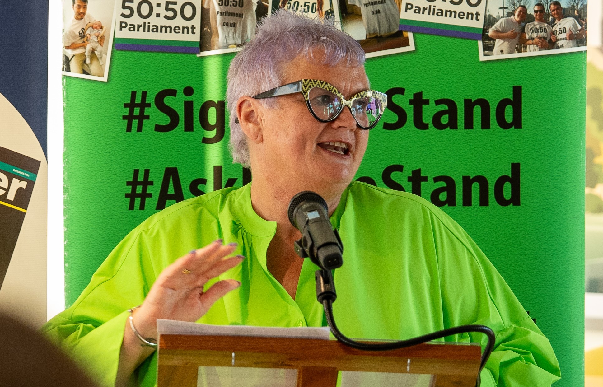 Carolyn Harris MP stands at a podium delivering a speech at a reception.