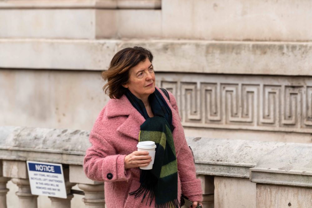 Sue Gray arrives at the Cabinet office in a pink coat carrying a coffee